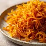 Close-up of air fryer sweet potato noodles with vibrant colors and textures