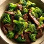 Close-up of beef and broccoli stir-fry with vibrant colors and a clean background.