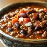 Close-up of chili in a crock pot slow cooker with beans and spices