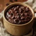 Close-up of a chocolate cake in a mug with a rich, moist texture, perfect for a quick microwave dessert.