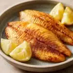 Close-up of tilapia cooked in an air fryer with a golden crispy texture