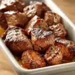 Close-up of Cowboy Butter Steak Bites with creamy sauce and herbs