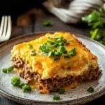 Close-up of a delicious egg bake casserole with ground beef, topped with melted cheese.