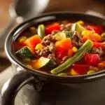 Close-up of ground beef vegetable soup with vibrant vegetables and rich broth
