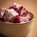 Close-up of a hearty slow cooker beef tallow dish with rich textures and warm lighting.