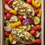 Herby feta lemon chicken and veggie sheet pan dinner with bright vegetables and herbs
