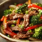 Close-up of a vibrant beef stir fry with colorful vegetables, showcasing a high protein meal.