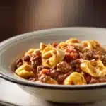 Close-up of high protein beef tortellini with rich sauce and herbs