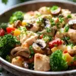 Close-up of a high protein chicken casserole with creamy sauce and herbs on a clean background.