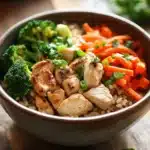 Close-up of a high protein chicken rice bowl with vibrant colors and fresh ingredients.