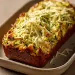Close-up of keto zucchini garlic bread with visible zucchini slices and garlic, on a clean background.