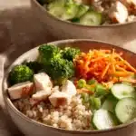 Close-up of low calorie chicken and rice bowls with vibrant vegetables