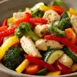 Close-up of a low calorie chicken and vegetable dish with vibrant colors and fresh ingredients.