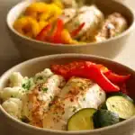 Delicious low carb dinner prep with vibrant vegetables and grilled chicken.