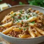 Close-up of creamy one pot beef and butter pasta with visible cheese and herbs.