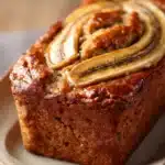 Close-up of peanut butter banana bread with a golden crust and soft texture.