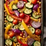Close-up of a colorful sheet pan vegetarian dinner with roasted vegetables and herbs