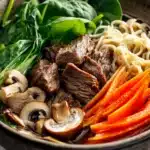 Close-up of slow cooker beef ramen noodle with vibrant vegetables and rich broth