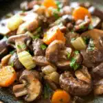 Close-up of a slow cooker pot roast with mushrooms in a bright, natural setting.