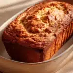 Close-up of Snickerdoodle Banana Bread with a golden crust and cinnamon sugar topping.