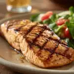 Close-up of Texas Roadhouse Grilled Salmon with grill marks and lemon garnish