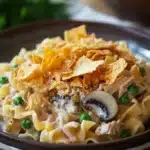 Close-up of a delicious tuna casserole with a golden crust, perfect for a comforting meal.