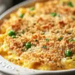 Close-up of a creamy tuna noodle casserole in a pan with a golden crust.