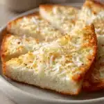 Close-up of zero carb garlic bread with a golden crust and herbs.