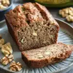 Close-up of zucchini bread with banana on a wooden board with a clean background