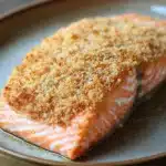 Close-up of air fryer salmon with panko crust on a white plate.