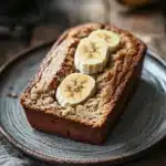 Close-up of freshly baked banana bread slices on a wooden board