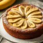 Close-up of a banana cake slice on a white plate with a clean background