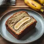 Close-up of a beautifully plated banana cake with a clean background