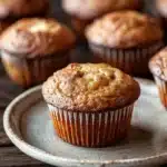 Close-up of delicious banana muffins with a golden brown top, perfect for breakfast or a snack.
