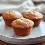 Close-up of freshly baked banana muffins perfect for toddlers, displayed on a clean background.