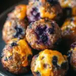 Close-up of blueberry muffin sausage balls with a golden crust on a clean background