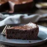 Close-up of a low sugar chocolate cake with rich texture and minimal background.