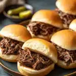 Close-up of crock pot beef on a bun with clear textures and bright lighting