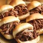Close-up of a crock pot beef on a bun with a clean background