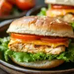 Close-up of chicken breast burgers with fresh toppings on a clean background