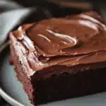 Close-up of a delicious sheet cake with a smooth frosting and decorative toppings.