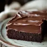 Close-up of a delicious sheet cake with creamy frosting and sprinkles.