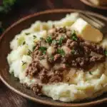 Close-up of a hearty ground beef dinner with mashed potatoes on a plate.