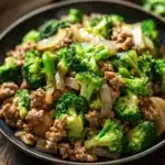 Close-up of a ground turkey and broccoli dish with bright, warm lighting.