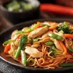 Close-up of high protein chicken lo mein with vegetables and a light sauce