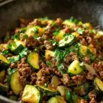 Close-up of a high protein ground beef zucchini dish with vibrant colors and textures.