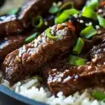 Close-up of honey butter garlic steak and rice skillet with a warm, appetizing presentation.