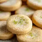 Close-up of key lime shortbread cookies on a white plate with a clean background.