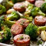 Close-up of kielbasa broccoli sheet pan dinner with vibrant vegetables and sausage.