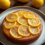 Close-up of a lemon cake upside down with bright, clear textures and minimal background.
